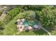 Aerial view of home's backyard showcases resort style pool, mature tropical landscaping, and outdoor living spaces at 8244 Oakland Pl, Orlando, FL 32819