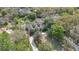 Aerial view of a sprawling estate featuring lush landscaping, mature trees, a pool, and a private driveway at 8244 Oakland Pl, Orlando, FL 32819