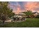 Expansive backyard retreat showcasing a sparkling pool, patio lounge, and lush green landscaping, perfect for relaxation at 8244 Oakland Pl, Orlando, FL 32819