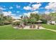 Gorgeous backyard pool area with a rock waterfall feature, lounge chairs, and beautiful landscaping at 8244 Oakland Pl, Orlando, FL 32819