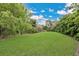 Expansive backyard featuring lush greenery, perfect for outdoor activities and relaxation at 8244 Oakland Pl, Orlando, FL 32819