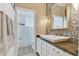 Bathroom with single vanity, mosaic tiling, and a glass enclosed bathtub with shower at 8244 Oakland Pl, Orlando, FL 32819