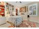 Charming bedroom featuring natural light, decorative pillows, and musician-themed wall decor at 8244 Oakland Pl, Orlando, FL 32819