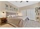 Neutral bedroom features a comfy king bed, and bright white closet doors and trim at 8244 Oakland Pl, Orlando, FL 32819