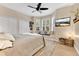 Comfortable bedroom with a TV, and cozy seating area with pillows by a bay window providing ample light at 8244 Oakland Pl, Orlando, FL 32819