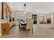 Dining area with wooden table and chairs, a decorative light fixture, and hardwood floors throughout at 8244 Oakland Pl, Orlando, FL 32819