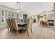 Dining room features a table with seating for eight, a bay window, and hardwood floors at 8244 Oakland Pl, Orlando, FL 32819