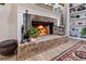 Close-up of a cozy brick fireplace featuring a decorative mantel, hearth and adjacent built-in bookshelves at 8244 Oakland Pl, Orlando, FL 32819