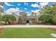 Stately brick home with a well-manicured lawn and mature trees creating a welcoming and elegant curb appeal at 8244 Oakland Pl, Orlando, FL 32819
