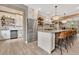 Bright, modern kitchen with a large island, stainless steel appliances and wooden shelving, perfect for entertaining at 8244 Oakland Pl, Orlando, FL 32819