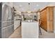 Spacious kitchen with an island, stainless steel refrigerator, custom cabinetry, and barstool seating at 8244 Oakland Pl, Orlando, FL 32819