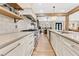 Long kitchen with stainless steel appliances, custom cabinetry, and an island with countertop seating at 8244 Oakland Pl, Orlando, FL 32819