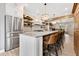 Bright kitchen featuring an island with barstool seating, stainless steel appliances, and pendant lighting at 8244 Oakland Pl, Orlando, FL 32819