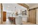 Stylish kitchen with an island, white cabinetry, exposed wood beams, and decorative tile backsplash at 8244 Oakland Pl, Orlando, FL 32819