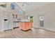 Open kitchen with white cabinets, contrasting island, and clerestory windows at 8244 Oakland Pl, Orlando, FL 32819