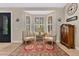 Cozy sitting area with a large bay window, two chairs, and an ornate decorative rug on hardwood floors at 8244 Oakland Pl, Orlando, FL 32819