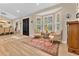 Inviting living room features a bay window, hardwood floors and two elegant upholstered chairs at 8244 Oakland Pl, Orlando, FL 32819