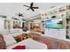 Spacious living room with built-in shelving, lots of natural light, and a large sectional sofa at 8244 Oakland Pl, Orlando, FL 32819