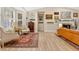 Sitting area with hardwood floors and furniture, leading to a living room with decoratively adorned walls at 8244 Oakland Pl, Orlando, FL 32819