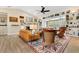 Living room features hardwood floors, furniture, fireplace, and open access to an adjacent room with shelving at 8244 Oakland Pl, Orlando, FL 32819