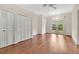 Bright living area with hardwood floors, large closets, and access to outdoor space through French doors at 8244 Oakland Pl, Orlando, FL 32819