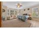 Serene main bedroom featuring a large bed, sitting area, ample natural light, and a ceiling fan at 8244 Oakland Pl, Orlando, FL 32819