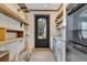 Convenient pantry with backyard access, stainless steel appliances, custom cabinets, and open shelving at 8244 Oakland Pl, Orlando, FL 32819