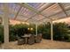 Charming outdoor patio with a pergola, string lights, and a comfortable dining set for entertaining at 8244 Oakland Pl, Orlando, FL 32819