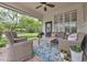 Covered brick patio featuring wicker seating, a ceiling fan, plants, and a view of the backyard and lawn at 8244 Oakland Pl, Orlando, FL 32819