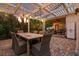 Inviting patio with a dining table, comfortable seating, and overhead lighting for evening gatherings at 8244 Oakland Pl, Orlando, FL 32819