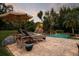 Backyard pool with a rock waterfall feature, lounge chairs, and beautiful tropical landscaping at 8244 Oakland Pl, Orlando, FL 32819
