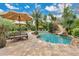 Resort style pool area complete with waterslide, sun loungers and lush tropical landscaping at 8244 Oakland Pl, Orlando, FL 32819