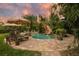 Tropical pool featuring waterfall, slide, lush landscaping, and ample seating areas with paver decking at 8244 Oakland Pl, Orlando, FL 32819