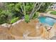 A thrilling water slide flowing into a sparkling pool, surrounded by greenery at 8244 Oakland Pl, Orlando, FL 32819