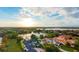 Breathtaking aerial perspective of a luxury estate overlooking a serene lake, nestled within a vibrant and picturesque community at 8336 Boyla Ct, Windermere, FL 34786