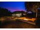 Lush backyard featuring a screened-in porch with a fireplace and an outdoor seating area with a fire pit at 8336 Boyla Ct, Windermere, FL 34786