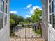 View from the balcony showing a beautiful exterior property view of driveway, lush greenery and mature trees at 8336 Boyla Ct, Windermere, FL 34786