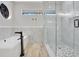 Modern bathroom featuring a tub, shower and marble tile work, and stylish black fixtures at 8336 Boyla Ct, Windermere, FL 34786