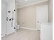 Bright bathroom featuring a glass-enclosed shower, white cabinets, and light wood-look tile floor at 8336 Boyla Ct, Windermere, FL 34786