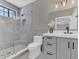 Updated bathroom offers a tiled glass shower, updated vanity, and gray accents with updated lighting at 8336 Boyla Ct, Windermere, FL 34786
