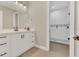Bathroom boasts double vanity, framed mirror, wood-look tile floors and glass shower with tile surround at 8336 Boyla Ct, Windermere, FL 34786