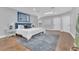 Primary bedroom features hardwood floors, area rug, a queen bed, and modern blue and gray artwork at 8336 Boyla Ct, Windermere, FL 34786