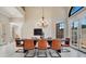 Bright dining room with a modern chandelier and a contemporary black dining table with leather chairs at 8336 Boyla Ct, Windermere, FL 34786