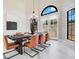Dining room with modern chandelier, large table, leather chairs, and view to the backyard at 8336 Boyla Ct, Windermere, FL 34786