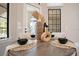Close-up view of a dining table with elegant place settings and decorative vases at 8336 Boyla Ct, Windermere, FL 34786