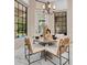 A dining table with stylish chairs and modern lighting at 8336 Boyla Ct, Windermere, FL 34786