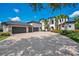 Beautiful home featuring a circular driveway, lush landscaping, and an attached three-car garage at 8336 Boyla Ct, Windermere, FL 34786