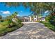 Beautiful home featuring a circular driveway, lush landscaping, and an attached three-car garage at 8336 Boyla Ct, Windermere, FL 34786