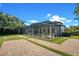 Wide exterior view of property showcasing landscaping and brick paver driveway and walkway at 8336 Boyla Ct, Windermere, FL 34786