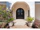 Inviting front entrance with double doors, stone accents, and decorative potted plants at 8336 Boyla Ct, Windermere, FL 34786
